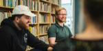 two PhD candidates having an unformal chat in the library.